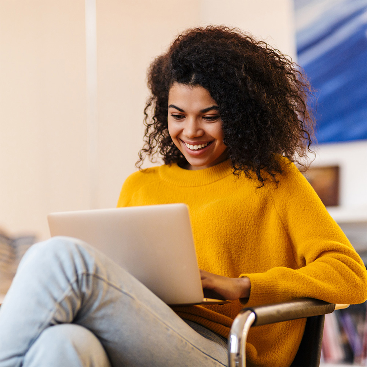 Woman looking at her computer smiling