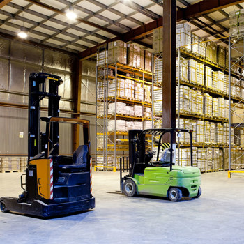 A forklift parked in a shipping warehouse