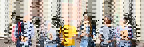 College students standing outside of a school building