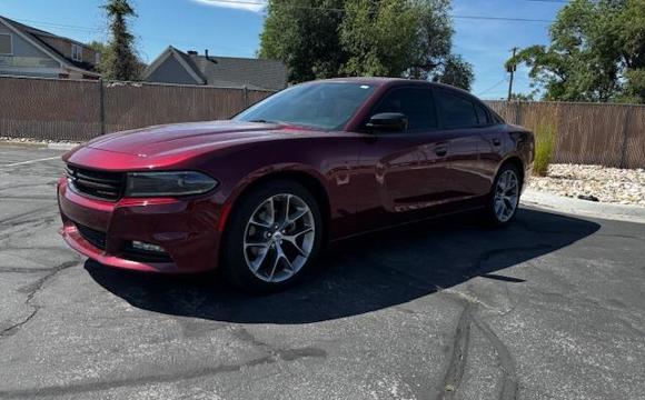 A red car parked and for sale.