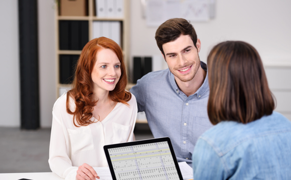 A young couple meeting with a financial planner