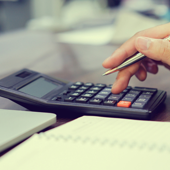 Laptop, Calculator, Notebook on a table