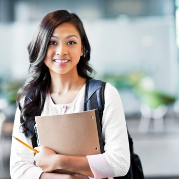 Female student with a backpack holding her notebook.