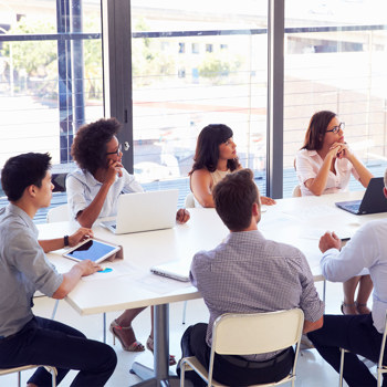 Employees training in a windowed conference room