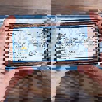 A phone taking a picture of a check