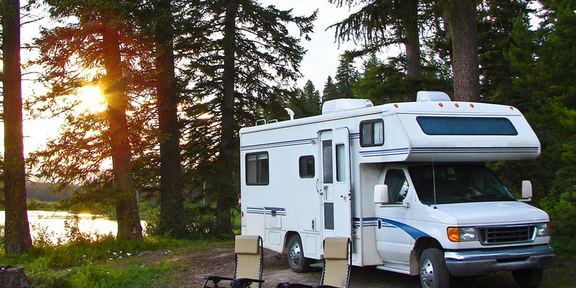 An RV parked in the forest.