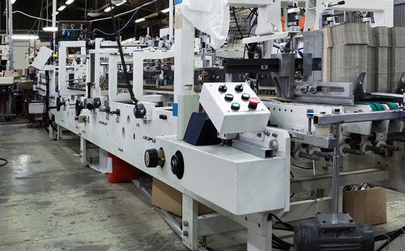 Industrial manufacturing equipment operating inside a large factory