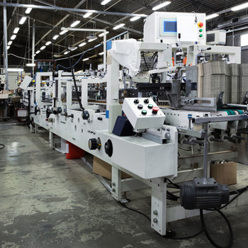 Industrial manufacturing equipment operating inside a large factory