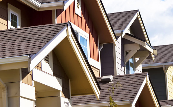 A row of colorful townhomes under a blue sky