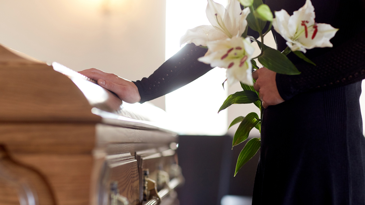 A mourner at a casket