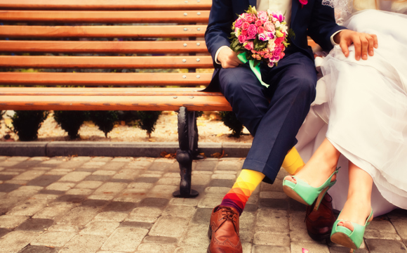 Newly wedded couple sitting on a bench