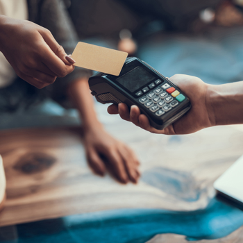 Women using contactless option to pay with her card.
