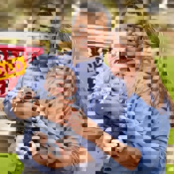 Young family celebrating the purchase of their first home.