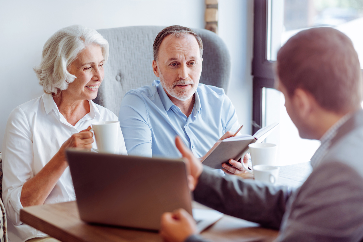 An older couple talking to an advisor