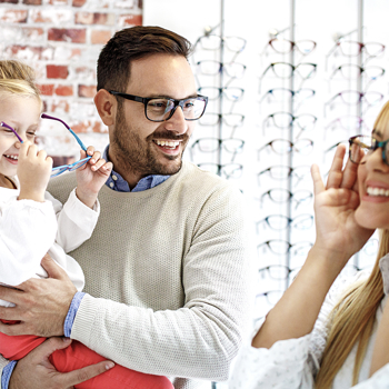 A family trying on frames in an optometrist's showroom.