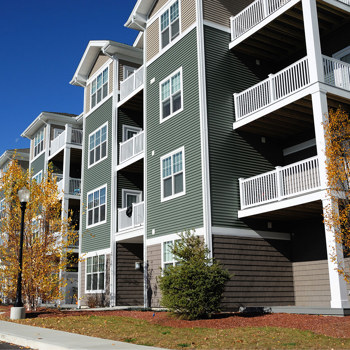 A large green apartment building.
